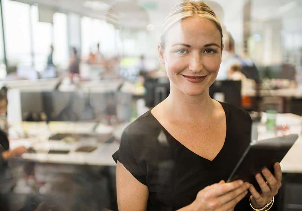 Two businesswomen looking over notes.